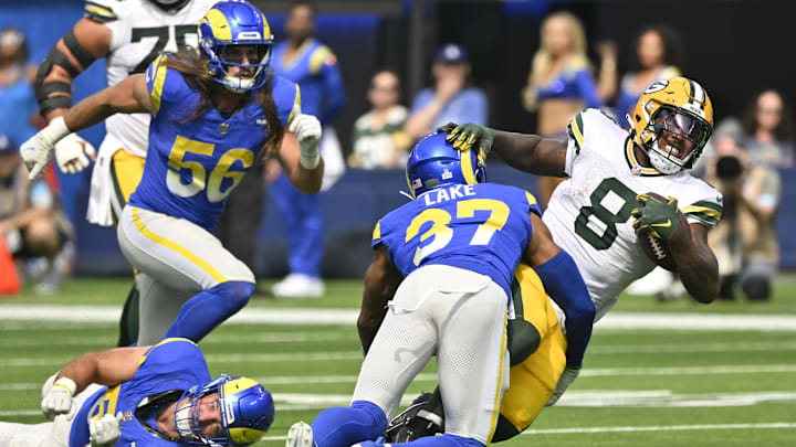 Oct 6, 2024; Inglewood, California, USA; Green Bay Packers running back Josh Jacobs (8) is tackled by Los Angeles Rams safety Quentin Lake (37) during the first quarter at SoFi Stadium. Mandatory Credit: Robert Hanashiro-Imagn Images