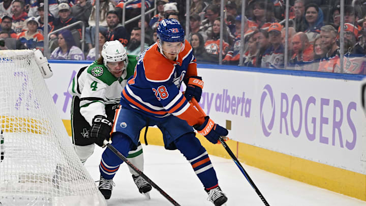 Nov 25, 2025; Edmonton, Alberta, CAN;  Dallas Stars defenseman Mro Heiskanen and Edmonton Oilers centre Jack Roslovic  (28) chase the puck during the first period at Rogers Place. Mandatory Credit: Walter Tychnowicz-Imagn Imaged 