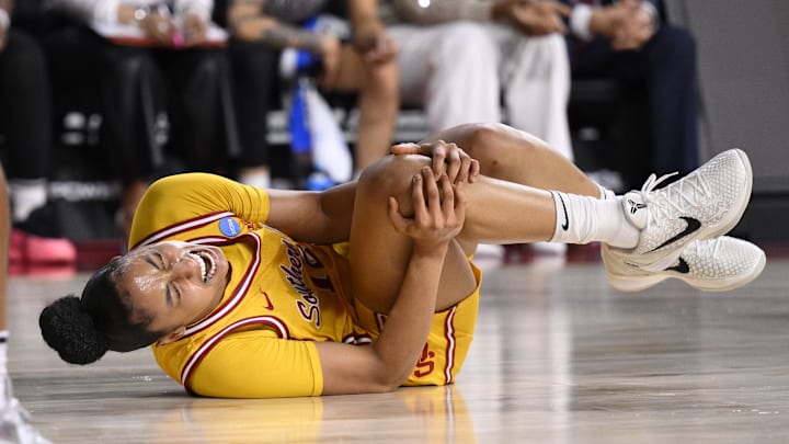 Mar 24, 2025; Los Angeles, California, USA; USC Trojans guard JuJu Watkins (12) grabs her knee after falling to the floor during an NCAA Tournament second round game against the Mississippi State Bulldogs at Galen Center. Mandatory Credit: Robert Hanashiro-Imagn Images