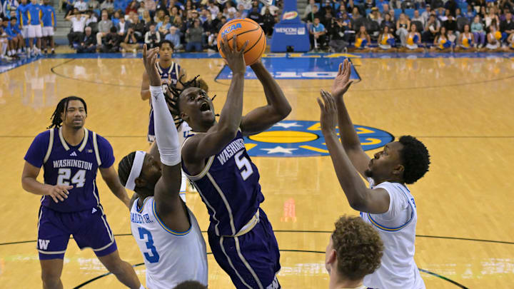 Feb 7, 2026; Los Angeles, California, USA;  Washington Huskies guard Zoom Diallo (5) drives past UCLA Bruins guard Eric Dailey Jr. (3) and forward Xavier Booker (1) in the second half at Pauley Pavilion presented by Wescom Financial. Mandatory Credit: Jayne Kamin-Oncea-Imagn Images