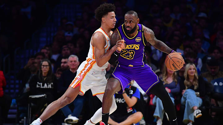 Jan 3, 2025; Los Angeles, California, USA; Los Angeles Lakers forward LeBron James (23) moves the ball against Atlanta Hawks forward Jalen Johnson (1) during the first half at Crypto.com Arena. Mandatory Credit: Gary A. Vasquez-Imagn Images