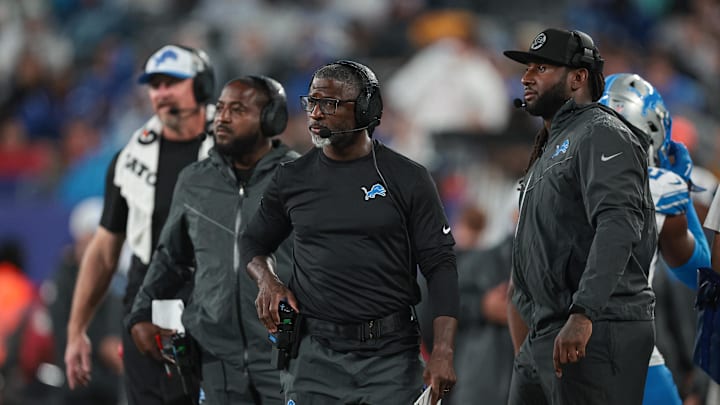 Aug 8, 2024; East Rutherford, New Jersey, USA; Detroit Lions defensive coordinator Aaron Glenn, center, and linebackers coach Kelvin Sheppard, right, look on during the second half against the New York Giants at MetLife Stadium. Mandatory Credit: Vincent Carchietta-Imagn Images
