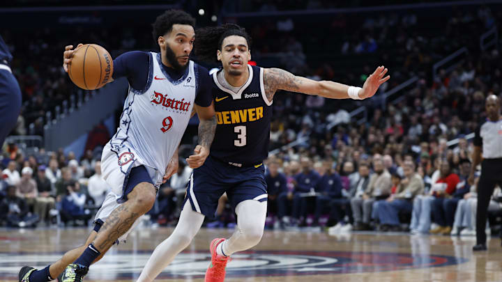 Dec 7, 2024; Washington, District of Columbia, USA; Washington Wizards forward Justin Champagnie (9) drives to the basket as Denver Nuggets guard Julian Strawther (3) defends in the fourth quarter at Capital One Arena. Mandatory Credit: Geoff Burke-Imagn Images