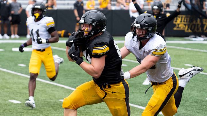 Iowa tight end DJ Vonnahme (81) runs to the endzone after catching a pass as Iowa linebacker Cam Buffington (33) defends Aug. 15, 2026 during the Kids Day at Kinnick open practice at Kinnick Stadium in Iowa City, Iowa.