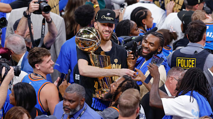 Oklahoma City Thunder forward Chet Holmgren (7) holds the NBA Finals Larry O'Brien Championship Trophy at the end of game seven of the 2025 NBA Finals at Paycom Center.