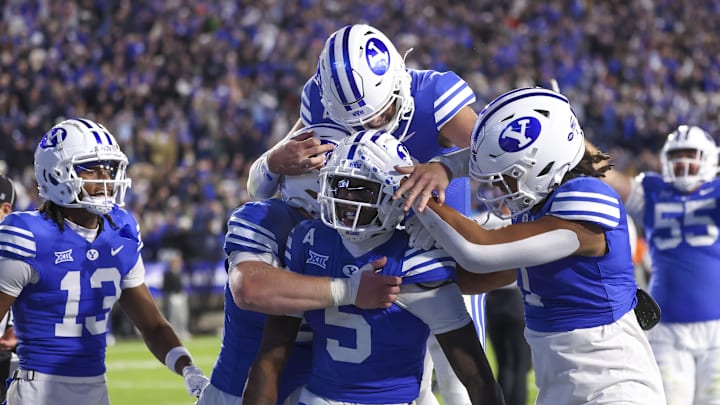 Oct 18, 2024; Provo, Utah, USA; Brigham Young Cougars wide receiver Darius Lassiter (5) celebrates a touchdown with teammates in the last minute of the game against the Oklahoma State Cowboys at LaVell Edwards Stadium. Mandatory Credit: Rob Gray-Imagn Images