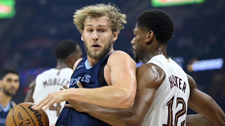 Memphis Grizzlies center Jock Landale works to the basket beside Cleveland Cavaliers forward De'Andre Hunter.