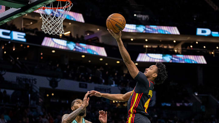 Nov 30, 2024; Charlotte, North Carolina, USA; Atlanta Hawks guard Kobe Bufkin (4) shoots the ball against Charlotte Hornets center Nick Richards (4) during the first quarter at Spectrum Center. Mandatory Credit: Scott Kinser-Imagn Images