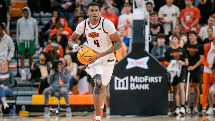 Nov 4, 2025; Stillwater, Oklahoma, USA; Oklahoma State Cowboys forward Christian Coleman (4) brings the ball up court during the first half against the Oral Roberts Golden Eagles at Gallagher-Iba Arena. Mandatory Credit: William Purnell-Imagn Images