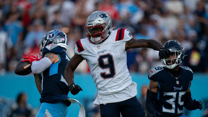 Tennessee Titans safety Amani Hooker intercepts a pass intended for New England Patriots wide receiver Kayshon Boutte