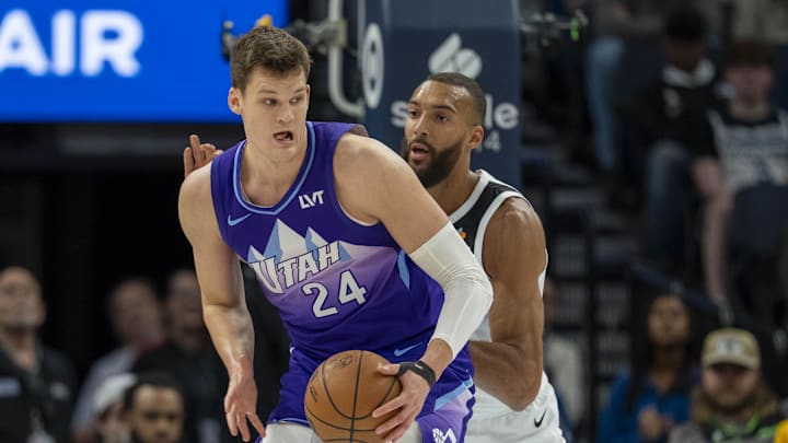 Mar 16, 2025; Minneapolis, Minnesota, USA; Utah Jazz center Walker Kessler (24) backs towards the basket as Minnesota Timberwolves center Rudy Gobert (27) plays defense in the first half at Target Center. Mandatory Credit: Jesse Johnson-Imagn Images