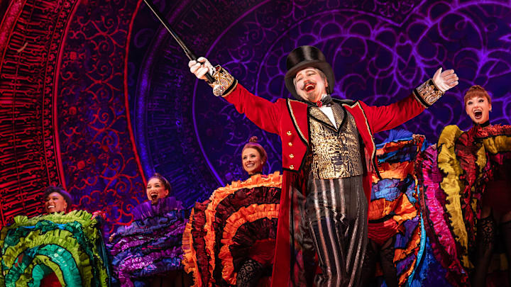 Robert Petkoff as Harold Zidler and the cast of the North American tour of Moulin Rouge! The Musical photo by Matthew Murphy