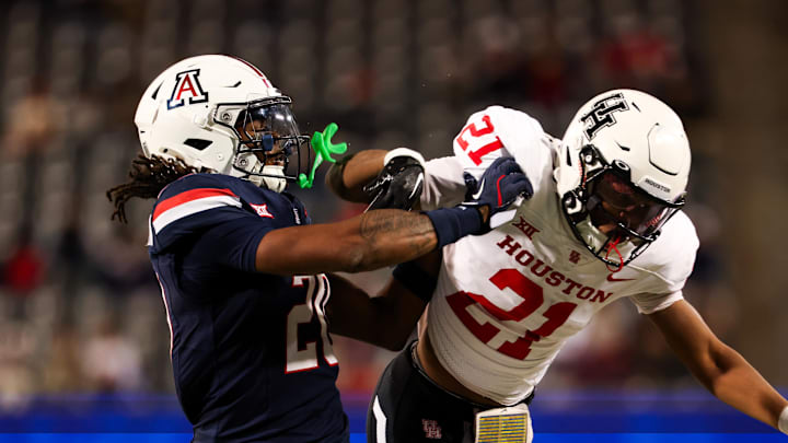 Nov 15, 2024; Tucson, Arizona, USA; Arizona Wildcats defensive back Marquis Groves-Killebrew (20) shoves Houston Cougars running back Stacy Sneed (21) during the third quarter at Arizona Stadium. Mandatory Credit: Aryanna Frank-Imagn Images Nov 15, 2024; Tucson, Arizona, USA; Arizona Wildcats defensive back Marquis Groves-Killebrew (20) shoves Houston Cougars running back Stacy Sneed (21) during the third quarter at Arizona Stadium. Mandatory Credit: Aryanna Frank-Imagn Images