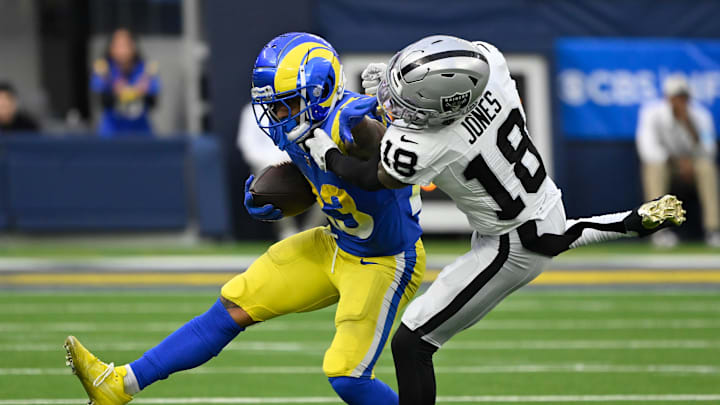 Oct 20, 2024; Inglewood, California, USA; Los Angeles Rams running back Kyren Williams (23) collides with Las Vegas Raiders cornerback Jack Jones (18) during the third quarter at SoFi Stadium. Mandatory Credit: Robert Hanashiro-Imagn Images