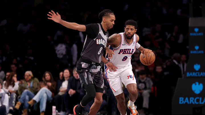 Feb 12, 2025; Brooklyn, New York, USA; Philadelphia 76ers forward Paul George (8) brings the ball up court against Brooklyn Nets forward Ziaire Williams (8) during the fourth quarter at Barclays Center. Mandatory Credit: Brad Penner-Imagn Images