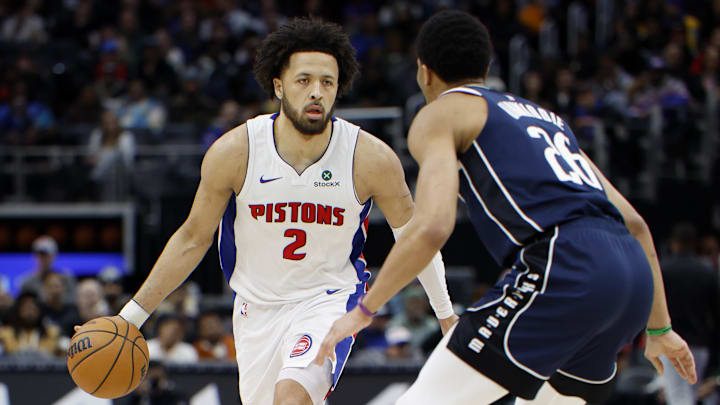 Jan 31, 2025; Detroit, Michigan, USA;  Detroit Pistons guard Cade Cunningham (2) dribbles defended by Dallas Mavericks guard Spencer Dinwiddie (26) in the second half at Little Caesars Arena. Mandatory Credit: Rick Osentoski-Imagn Images