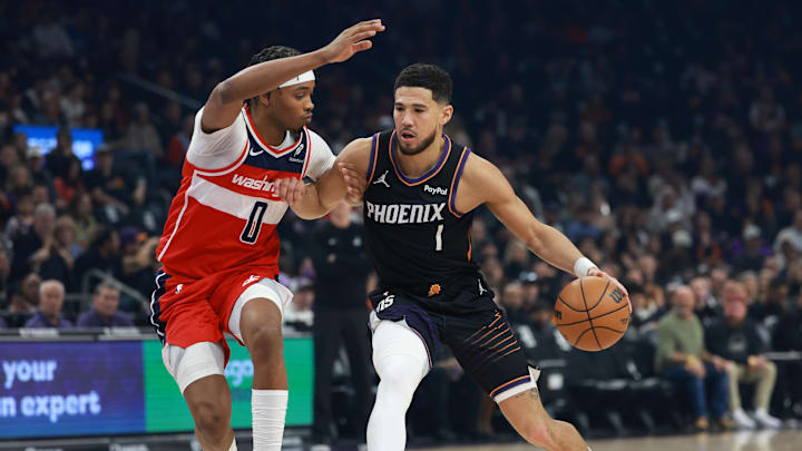 Jan 11, 2026; Phoenix, Arizona, USA; Phoenix Suns guard Devin Booker (1) against the Washington Wizards in the first half at Mortgage Matchup Center. Mandatory Credit: Mark J. Rebilas-Imagn Images