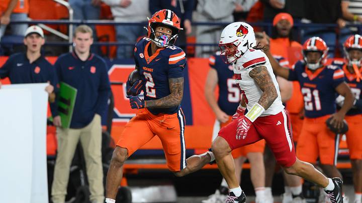 Oct 17, 2026; Syracuse, New York, USA; Syracuse Orange wide receiver Umari Hatcher (2) runs with the ball as Louisville Cardinals defensive back Koen Entringer (5) defends during the first half at the JMA Wireless Dome. Mandatory Credit: Rich Barnes-Imagn Images Oct 17, 2026; Syracuse, New York, USA; Syracuse Orange wide receiver Umari Hatcher (2) runs with the ball as Louisville Cardinals defensive back Koen Entringer (5) defends during the first half at the JMA Wireless Dome. Mandatory Credit: Rich Barnes-Imagn Images