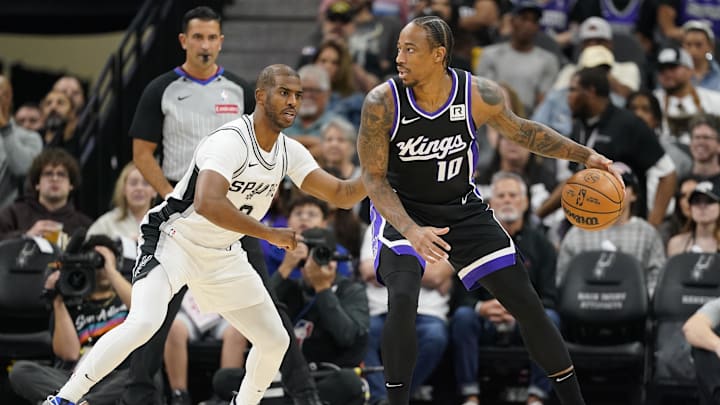 Nov 11, 2024; San Antonio, Texas, USA; Sacramento Kings center guard DeMar DeRozan (10) looks to pass the ball while defended by San Antonio Spurs guard Chris Paul (3) during the first half at Frost Bank Center. Mandatory Credit: Scott Wachter-Imagn Images