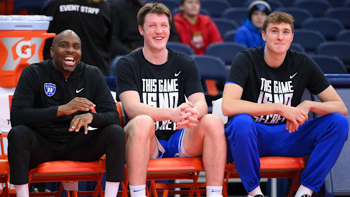 Feb 5, 2025; Syracuse, New York, USA; Duke Blue Devils assistant coach Emanuel Dildy (left) and guard Kon Knueppel (center) and guard Cooper Flagg (right) look on prior to the game against the Syracuse Orange at the JMA Wireless Dome. Mandatory Credit: Rich Barnes-Imagn Images