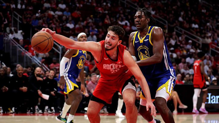 Nov 2, 2024; Houston, Texas, USA; Houston Rockets center Alperen Sengun (28) reaches for the ball against Golden State Warriors forward Kevon Looney (5) during the third quarter at Toyota Center. Mandatory Credit: Erik Williams-Imagn Images
