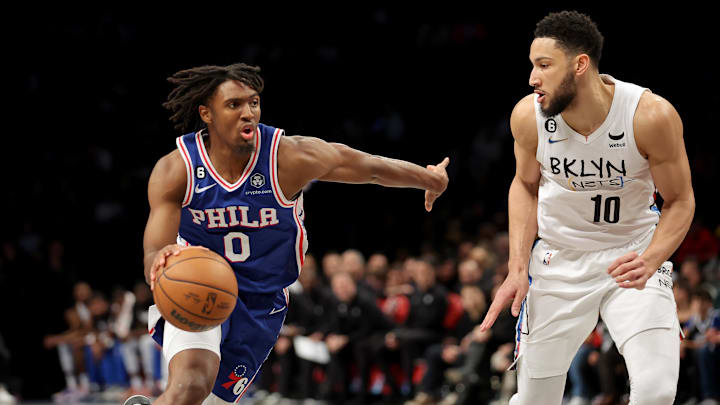 Feb 11, 2023; Brooklyn, New York, USA; Philadelphia 76ers guard Tyrese Maxey (0) drives to the basket against Brooklyn Nets guard Ben Simmons (10) during the second quarter at Barclays Center. Mandatory Credit: Brad Penner-Imagn Images