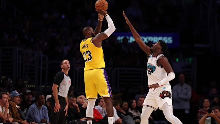 Nov 13, 2024; Los Angeles, California, USA;  Los Angeles Lakers forward LeBron James (23) shoots the ball over Memphis Grizzlies forward Jaren Jackson Jr. (13) during the fourth quarter at Crypto.com Arena. Mandatory Credit: Kiyoshi Mio-Imagn Images