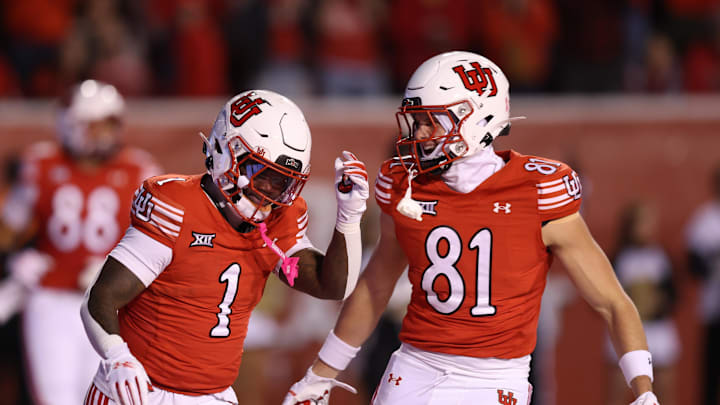 Utah Utes running back Wayshawn Parker (1) celebrates a touchdown against the Colorado Buffaloes with tight end JJ Buchanan (81) during the first quarter at Rice-Eccles Stadium.