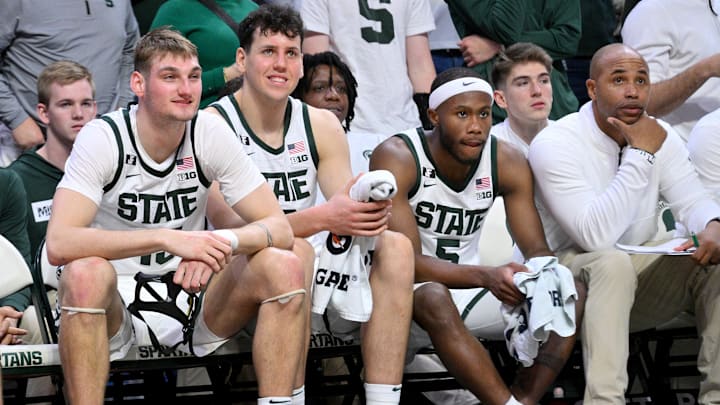 Nov 16, 2024; East Lansing, Michigan, USA; Michigan State Spartans center Carson Cooper (15), center Szymon Zapala (10) and guard Tre Holloman (5) look on from the bench during the second half against the Bowling Green Falcons at Jack Breslin Student Events Center. Mandatory Credit: Dale Young-Imagn Images Nov 16, 2024; East Lansing, Michigan, USA; Michigan State Spartans center Carson Cooper (15), center Szymon Zapala (10) and guard Tre Holloman (5) look on from the bench during the second half against the Bowling Green Falcons at Jack Breslin Student Events Center. Mandatory Credit: Dale Young-Imagn Images