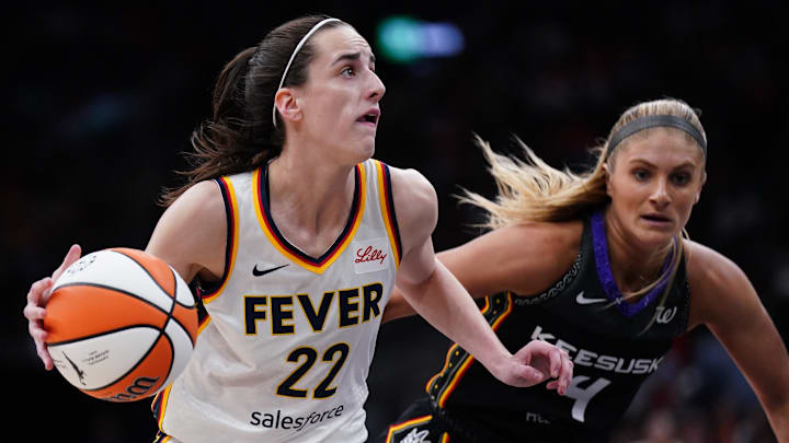 Jul 15, 2025; Boston, Massachusetts, USA; Indiana Fever guard Caitlin Clark (22) drives the ball against Connecticut Sun guard Jacy Sheldon (4) in the first quarter at TD Garden. Mandatory Credit: David Butler II-Imagn Images