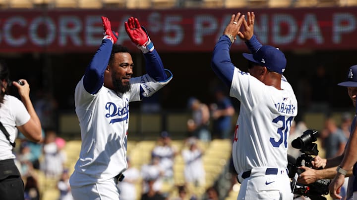 Aug 11, 2024; Los Angeles, California, USA;  Los Angeles Dodgers left fielder Teoscar Hernandez (37) celebrates with manager Dave Roberts (30) after hitting a game-winning RBI single in the bottom of the tenth inning against the Pittsburgh Pirates at Dodger Stadium. Mandatory Credit: Kiyoshi Mio-Imagn Images