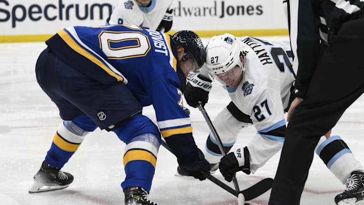 Nov 7, 2024; St. Louis, Missouri, USA; St. Louis Blues center Oskar Sundqvist (70) takes a face-off against Utah Hockey Club center Barrett Hayton (27) during the third period at Enterprise Center. Mandatory Credit: Jeff Le-Imagn Images