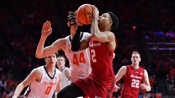Feb 10, 2026; Champaign, Illinois, USA;  Wisconsin Badgers guard Nick Boyd (2) drives to the basket against Illinois Fighting Illini forward Zvonimir Ivisic (44) during the second half at State Farm Center. 