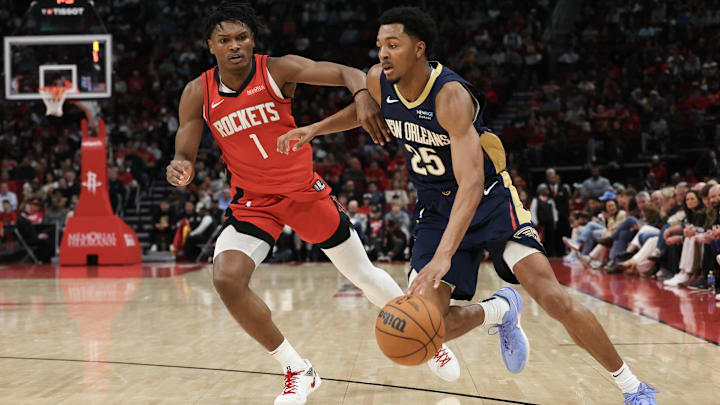 Dec 19, 2024; Houston, Texas, USA; New Orleans Pelicans guard Trey Murphy III (25) dribbles against Houston Rockets forward Amen Thompson (1) in the second quarter at Toyota Center. Mandatory Credit: Thomas Shea-Imagn Images