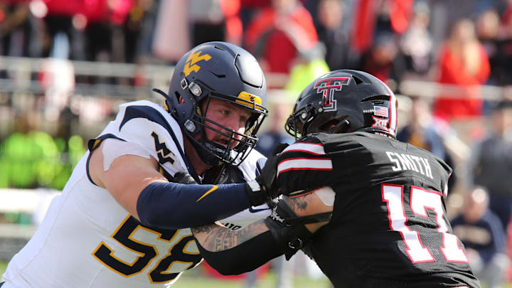 Nov 30, 2024; Lubbock, Texas, USA;  West Virginia Mountaineers offensive tackle Nick Malone (58) blocks Texas Tech Red Raiders defensive linebacker Isaac Smith (17) in the second half at Jones AT&T Stadium and Cody Campbell Field. Mandatory Credit: Michael C. Johnson-Imagn Images