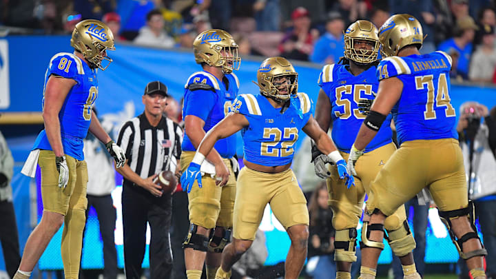 Nov 8, 2025; Pasadena, California, USA; UCLA Bruins running back Anthony Frias II (22) celebrates his touchdown scored against the Nebraska Cornhuskers with offensive lineman Julian Armella (74) during the second half at the Rose Bowl. Mandatory Credit: Gary A. Vasquez-Imagn Images