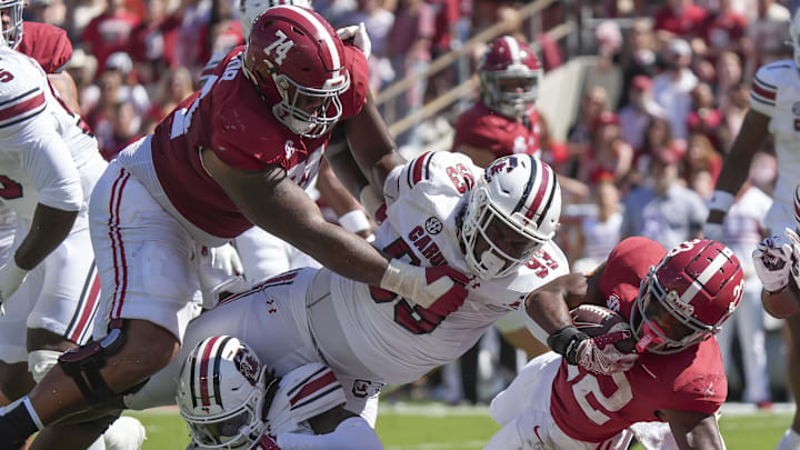 Oct 12, 2024; Tuscaloosa, Alabama, USA;  Alabama Crimson Tide running back Justice Haynes (22) lunges across the goal line as Alabama Crimson Tide offensive lineman Kadyn Proctor (74) blocks on South Carolina Gamecocks defensive tackle Nick Barrett (93) at Bryant-Denny Stadium. Mandatory Credit: Gary Cosby Jr.-Imagn Images