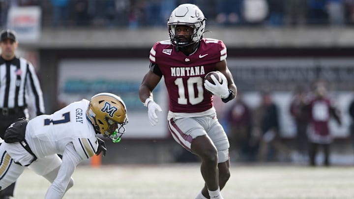 Montana Grizzlies running back Eli Gillman (10) carries the ball against Montana State Bobcats defensive back Tayden Gray (7)