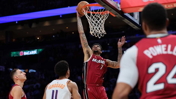 Jan 13, 2026; Miami, Florida, USA; Miami Heat center Kel'el Ware (7) scores against Phoenix Suns forward Oso Ighodaro (11) during the first quarter at Kaseya Center. Mandatory Credit: Sam Navarro-Imagn Images