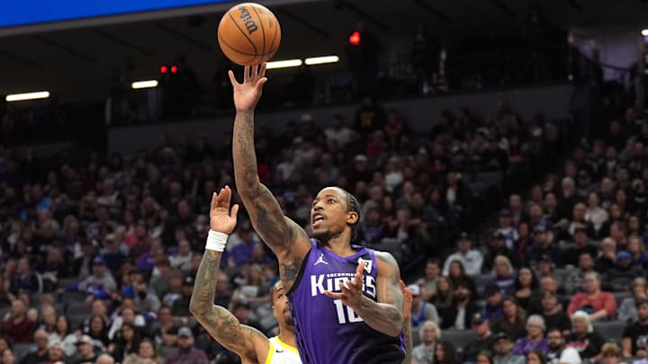 Dec 8, 2024; Sacramento, California, USA; Sacramento Kings forward DeMar DeRozan (front) shoots against Utah Jazz forward John Collins (back) during the second quarter at Golden 1 Center. Mandatory Credit: Darren Yamashita-Imagn Images Dec 8, 2024; Sacramento, California, USA; Sacramento Kings forward DeMar DeRozan (front) shoots against Utah Jazz forward John Collins (back) during the second quarter at Golden 1 Center. Mandatory Credit: Darren Yamashita-Imagn Images