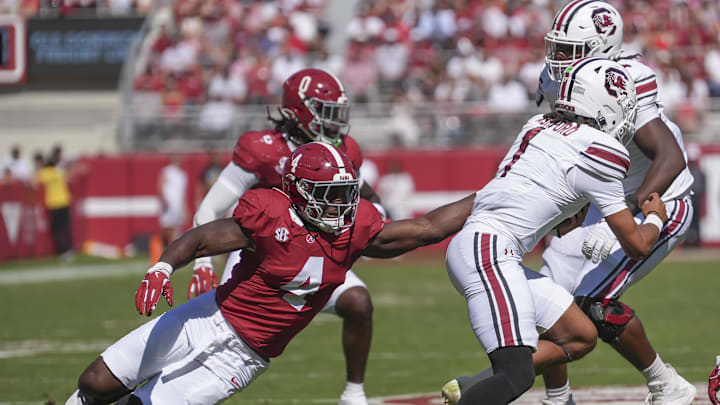 Oct 12, 2024; Tuscaloosa, Alabama, USA;  Alabama Crimson Tide linebacker Qua Russaw (4) tries to bring down South Carolina Gamecocks quarterback Robby Ashford (1) at Bryant-Denny Stadium. Mandatory Credit: Gary Cosby Jr.-Imagn Images