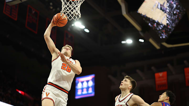 Dec 22, 2025; Charlottesville, Virginia, USA; Virginia Cavaliers forward Thijs de Ridder (28) dunks the ball as Cavaliers center Johann Grunloh (17) and American University Eagles forward Greg Jones (23) look on in the second half at John Paul Jones Arena. Mandatory Credit: Geoff Burke-Imagn Images