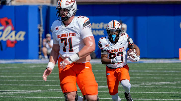 Oklahoma State running back Rodney Fields Jr. (20) runs the ball as Oklahoma State offensive lineman Dalton Cooper (71) blocks in the first half during an NCAA football game between Oklahoma State and Tulsa in Tulsa, Okla., on Saturday, Sept. 14, 2024.