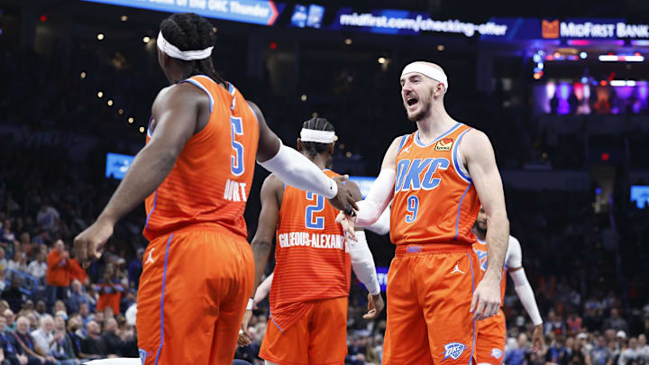 Dec 10, 2024; Oklahoma City, Oklahoma, USA; Oklahoma City Thunder guard Alex Caruso (9) celebrates with Oklahoma City Thunder guard Luguentz Dort (5) after scoring against the Dallas Mavericks during the second quarter at Paycom Center. Mandatory Credit: Alonzo Adams-Imagn Images