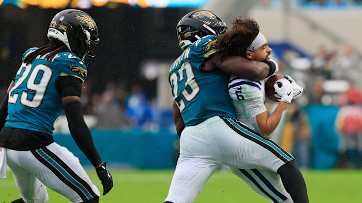 Jacksonville Jaguars linebacker Foye Oluokun (23) tackles Indianapolis Colts wide receiver Anthony Gould (6) as he loses his helmet during the second quarter of an NFL football game at EverBank Stadium, Sunday, Dec. 7, 2025, in Jacksonville, Fla. [Corey Perrine/Florida Times-Union]