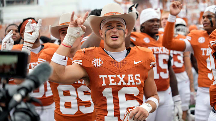 Texas Longhorns defensive back Michael Taaffe holds up his horns with the fans during the singing of the Eyes of Texas after a victory over the San Jose State Spartans