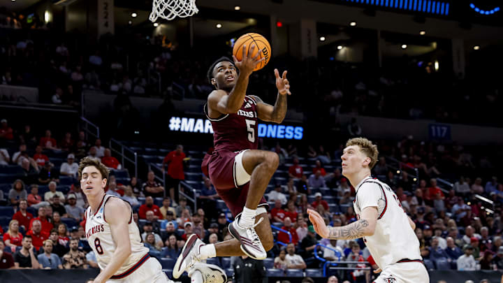 Texas A&M Aggies guard Jacari Lane takes a shot while Saint Mary's Gaels center Andrew McKeever defends during a first-round game of the men's 2026 NCAA Tournament at Paycom Center.