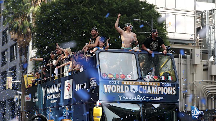 Nov 3, 2025; Los Angeles, CA, USA; Los Angeles Dodgers first baseman Enrique Hernandez (middle) and second baseman Miguel Rojas (right) acknowledges the crowd during the World Series championship parade at downtown Los Angeles. Mandatory Credit: Kiyoshi Mio-Imagn Images Nov 3, 2025; Los Angeles, CA, USA; Los Angeles Dodgers first baseman Enrique Hernandez (middle) and second baseman Miguel Rojas (right) acknowledges the crowd during the World Series championship parade at downtown Los Angeles. Mandatory Credit: Kiyoshi Mio-Imagn Images