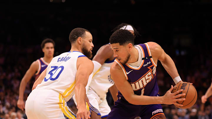 Apr 8, 2025; Phoenix, Arizona, USA; Golden State Warriors guard Stephen Curry (30) defends against Phoenix Suns guard Devin Booker (1) at Footprint Center. Mandatory Credit: Mark J. Rebilas-Imagn Images Apr 8, 2025; Phoenix, Arizona, USA; Golden State Warriors guard Stephen Curry (30) defends against Phoenix Suns guard Devin Booker (1) at Footprint Center. Mandatory Credit: Mark J. Rebilas-Imagn Images