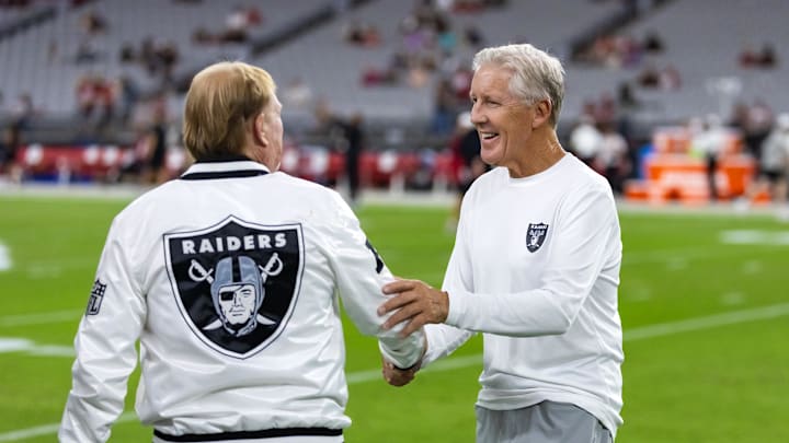 Aug 23, 2025; Glendale, Arizona, USA; Las Vegas Raiders head coach Pete Carroll (right) talks with owner Mark Davis against the Arizona Cardinals during a preseason NFL game at State Farm Stadium. Mandatory Credit: Mark J. Rebilas-Imagn Images